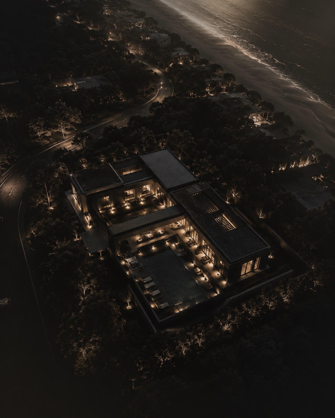 Vista aérea noturna de um projeto residencial junto à costa